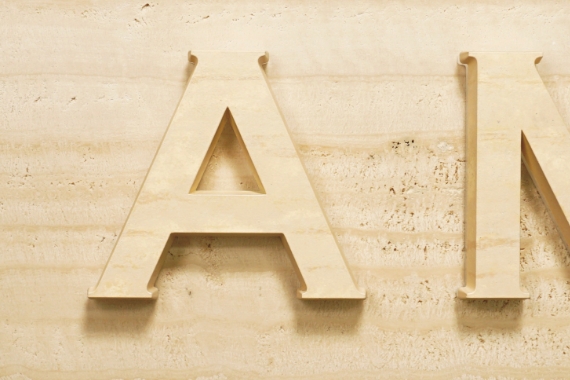 Completed with cut-out letters that look like travertine cut